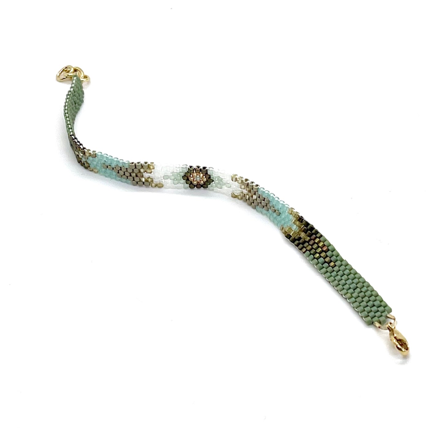Green beaded bracelet with ivory and gold seed beads in an arrow pattern. Hand woven peyote stitch bracelet.