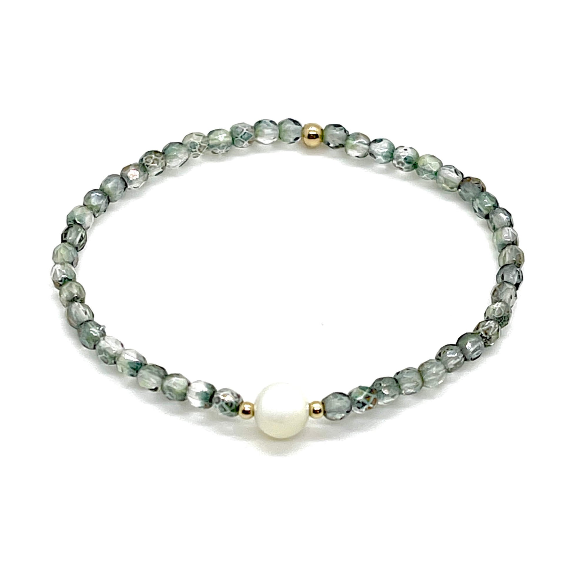 Green-grey crystal bracelet with mother-of-pearl center bead and small gold accent beads.