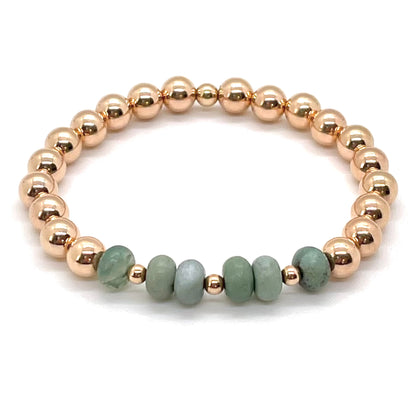 Green jasper bracelet with 6mm 14K rose gold filled beads on elastic stretch cord. Waterproof and tarnish resistant.