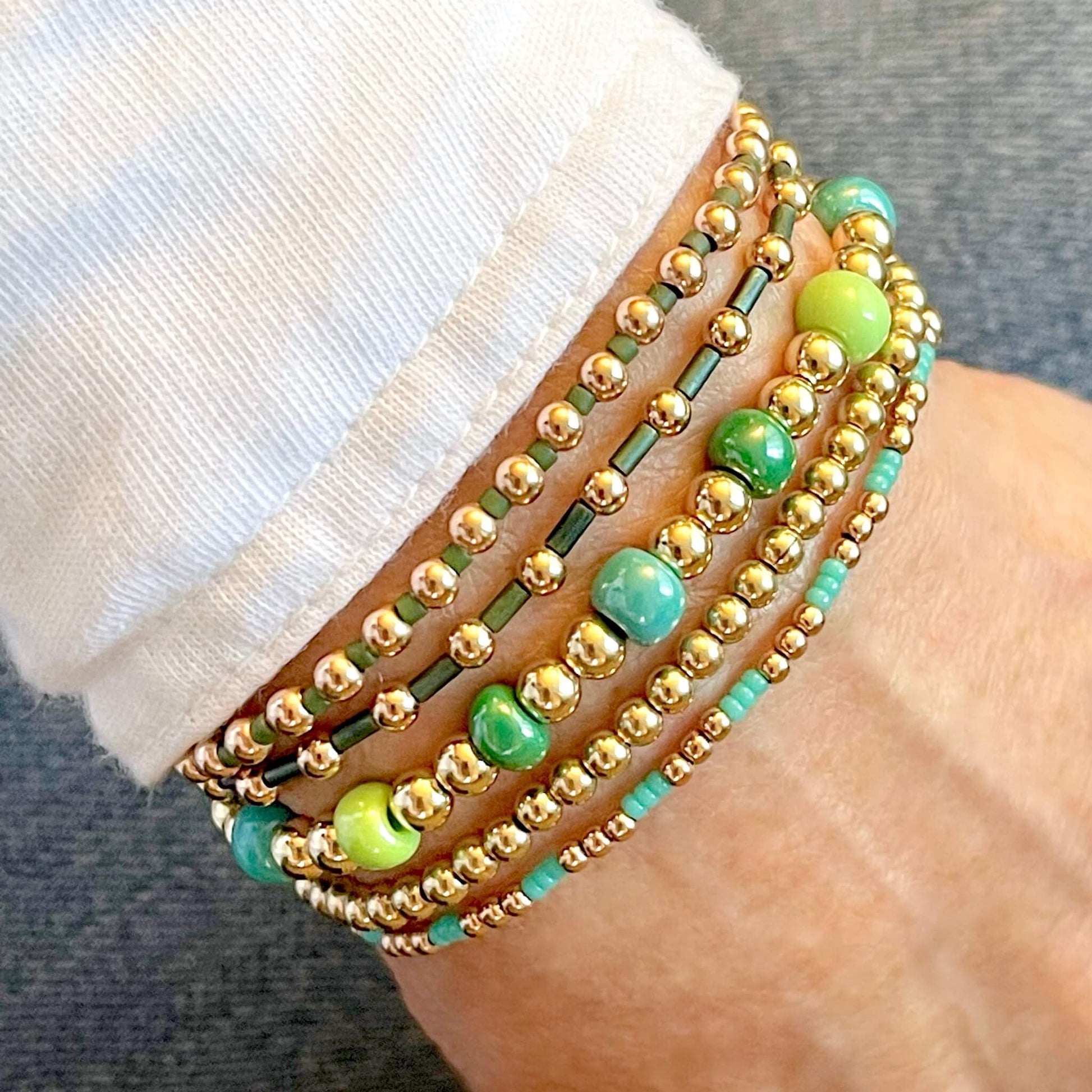 14K gold filled and monochomatic shades of green beaded ball stretch bracelet stack of 5.