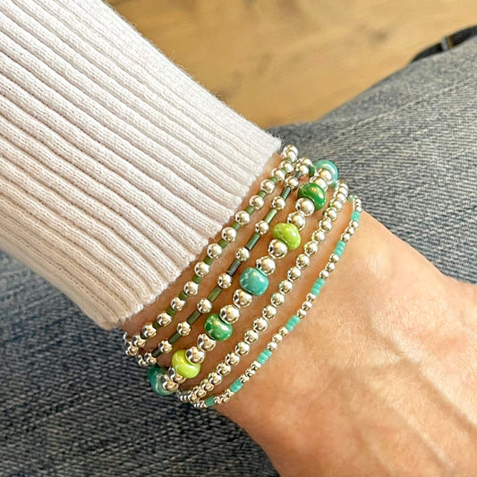 Silver bead bracelets with green beads. Beaded stretch bracelets.