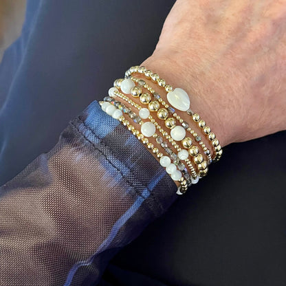 Grey crystal and gold beaded bracelets with round and heart mother-of-pearls.