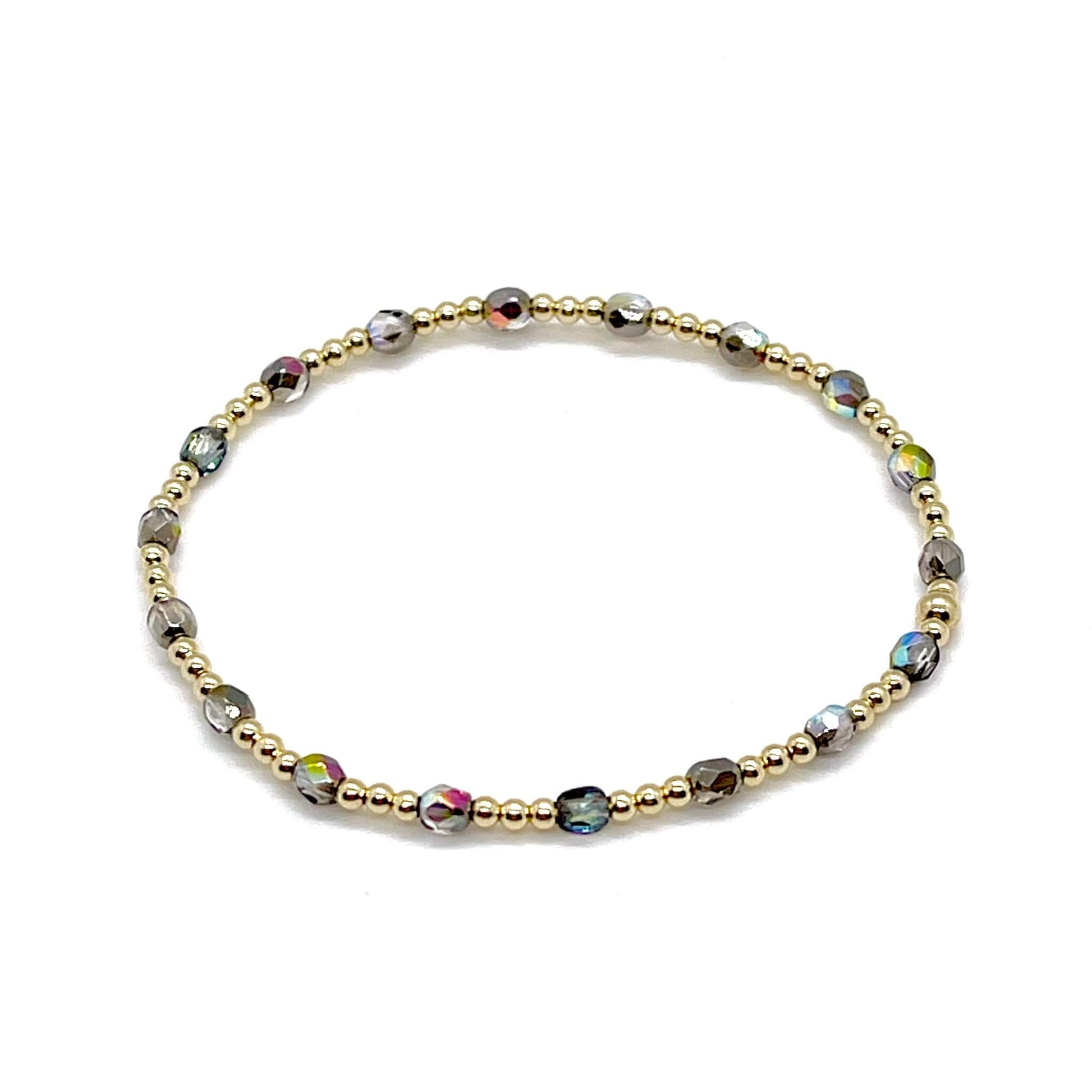 Grey-silver crystal bracelet with dainty 14K gold filled beads on a stretchy cord.