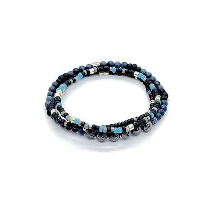 Men’s stretch bracelets with lava & blue dumortierite beads, blue, gray & silver seed beads, & black & gunmetal seed beads.
