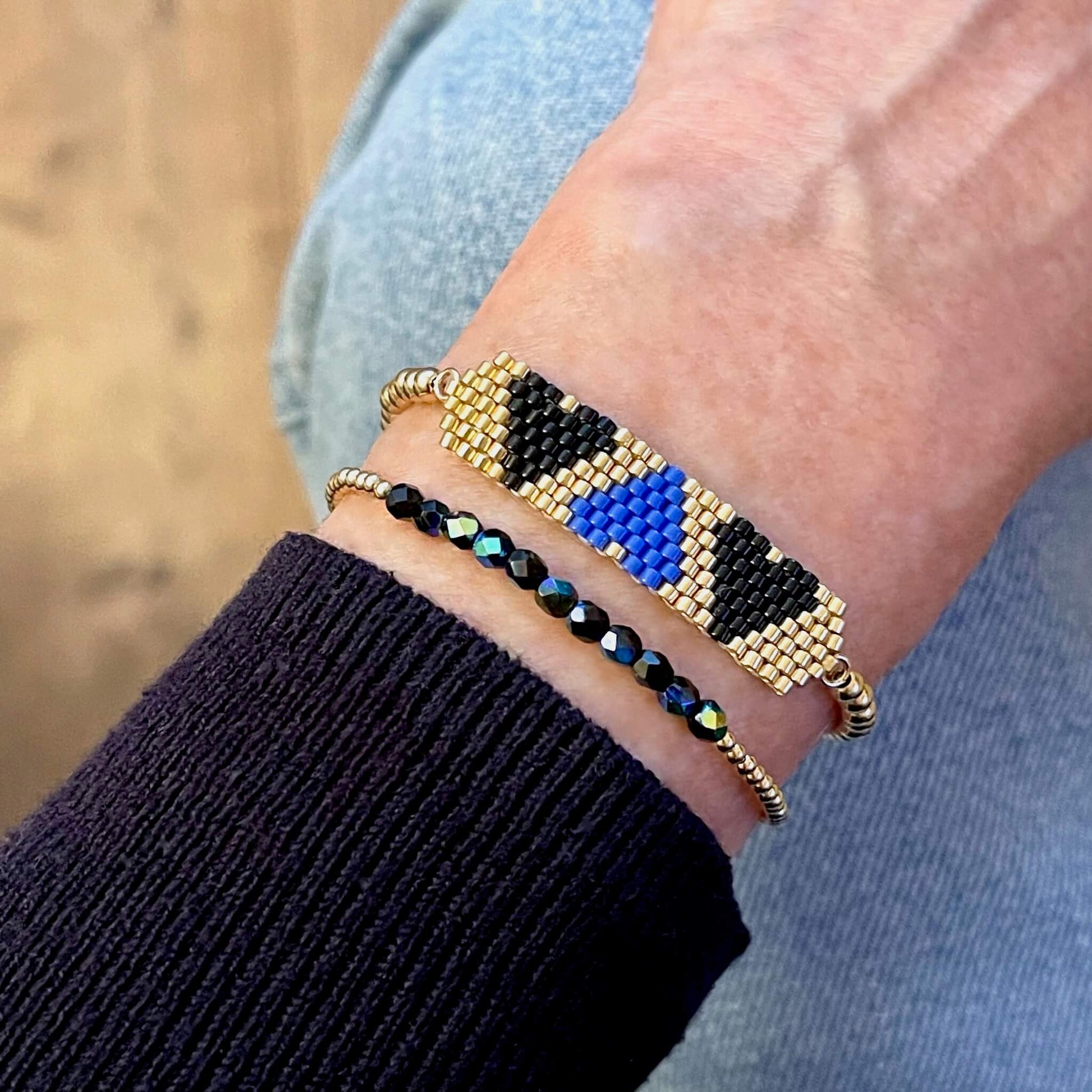 Heart beaded bracelet set with blue, black, and gold beads.