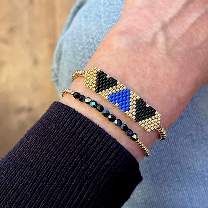 Heart beaded bracelet set with blue, black, and gold beads.