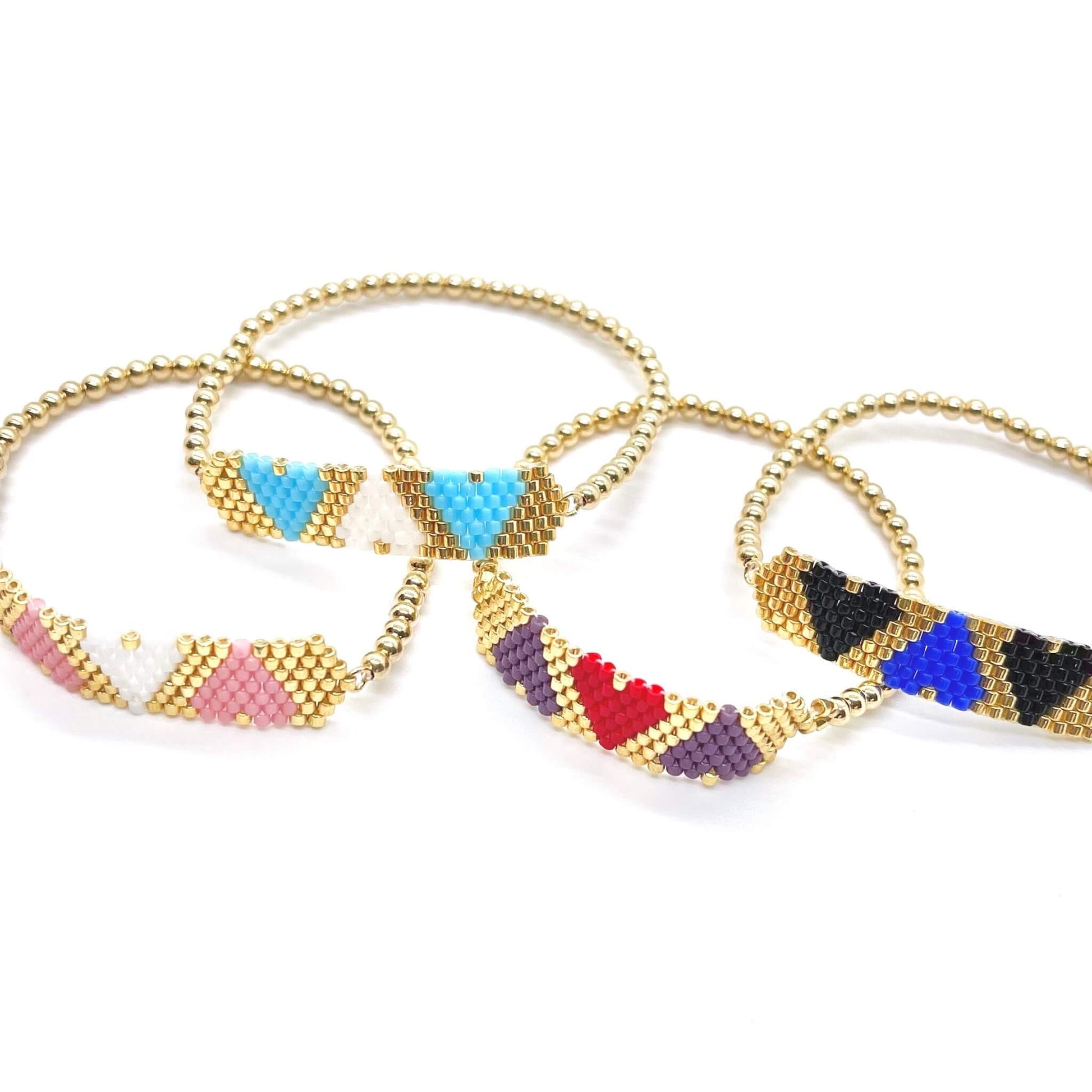 Heart trio beaded gold stretch bracelets with red, purple, blue, pink, and black seed bead hearts.