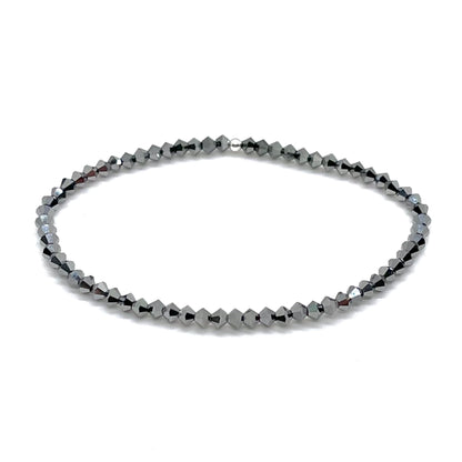 Dainty hematite bicone shaped crystal beads on elastic stretch cord. Handmade in NYC.