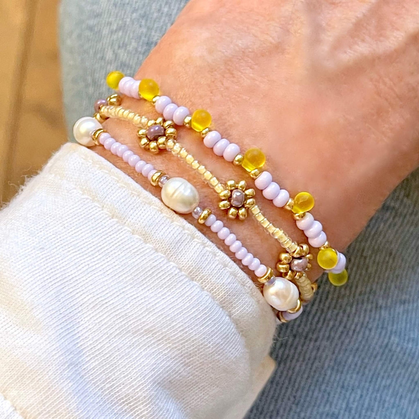 Lavender and yellow seed bead and freshwater pearl bracelet stack of 3. Delicate stretch bracelets for women.