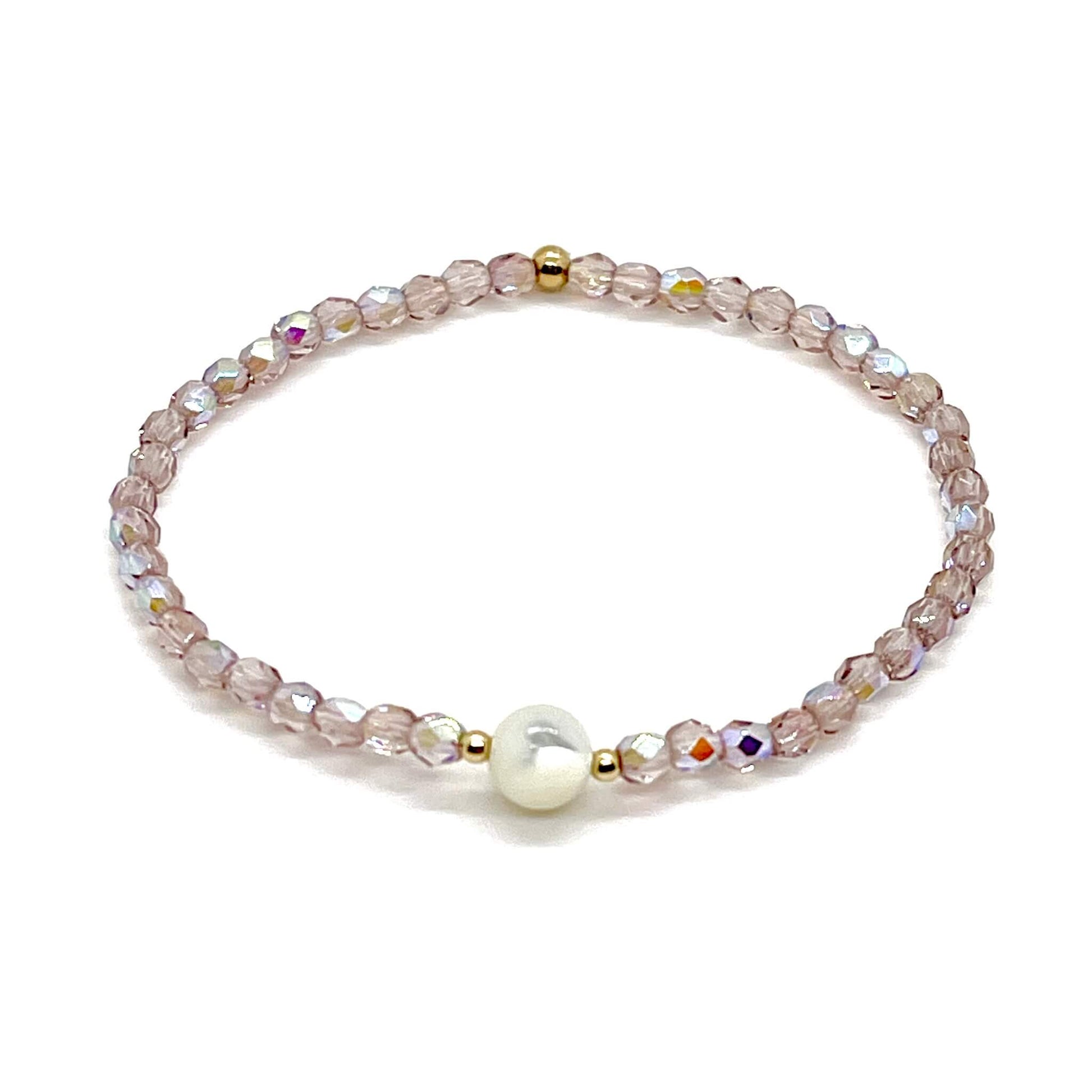 Light purple crystal bracelet with a mother-of-pearl center bead and small gold accent beads.