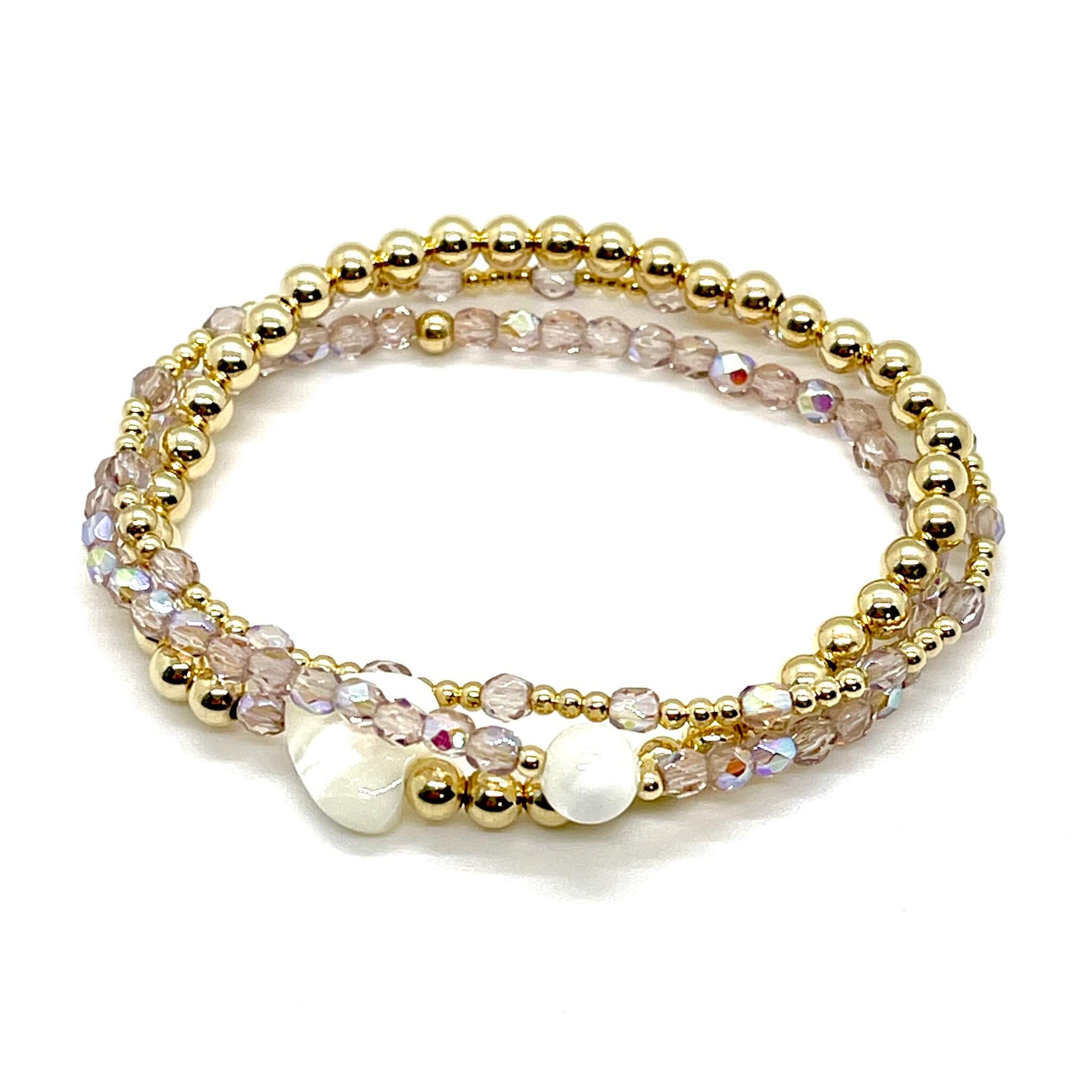 Light purple crystal and gold bracelet stack of 3. Womens handmade stretch bracelets wtih round and heart shaped mother-of-pearl accent beads.