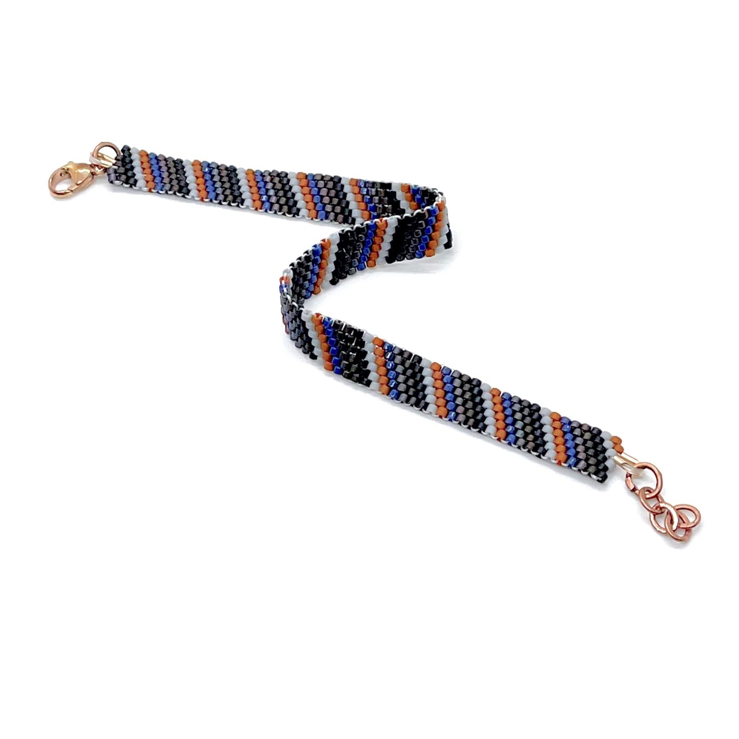Men’s hand woven beaded peyote bracelet with clasp and stripes in black, brown, bronze, blue, rust, and gray seed beads.