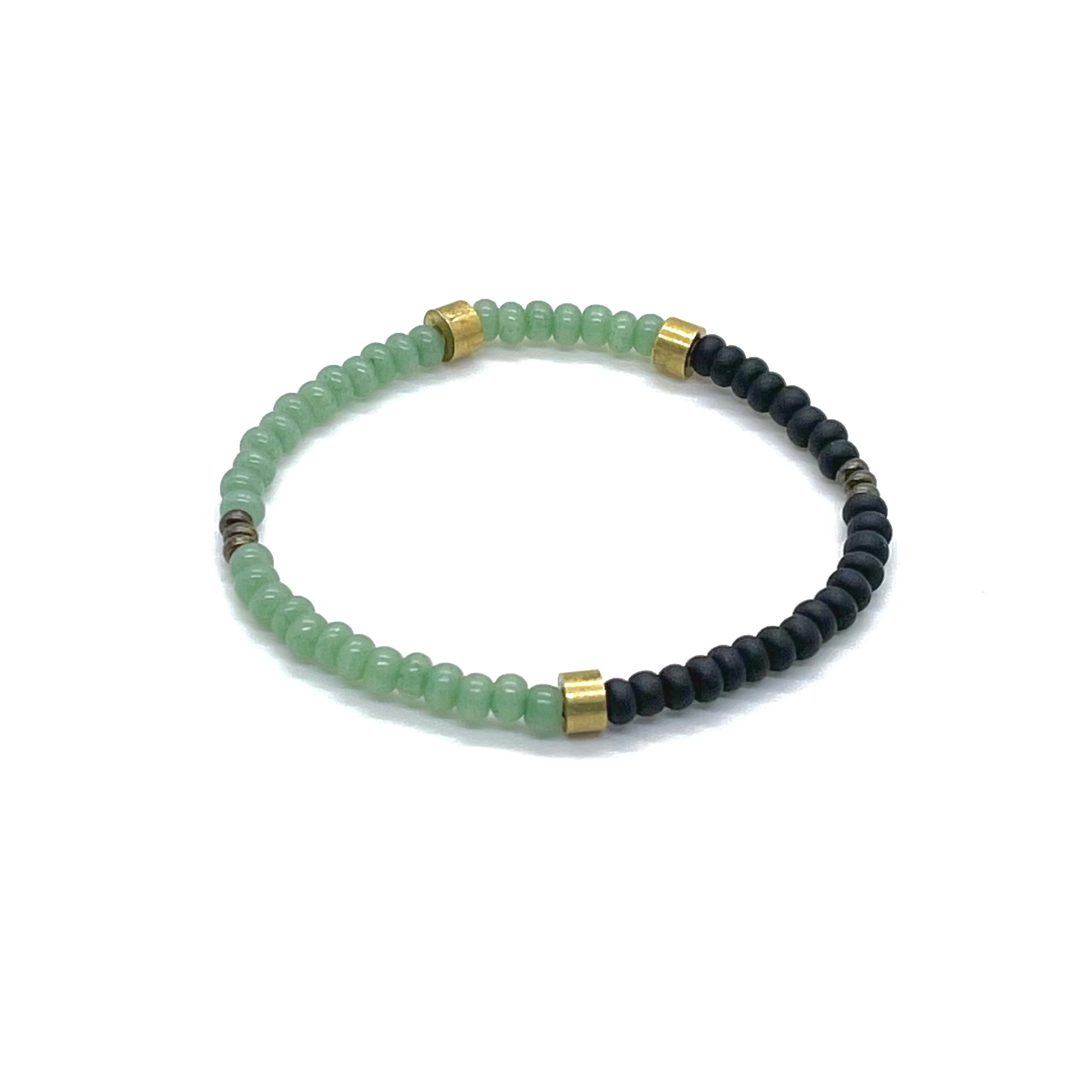 Men's green bracelet with green and black seed beads and raw brass beads on elastic stretch cord.