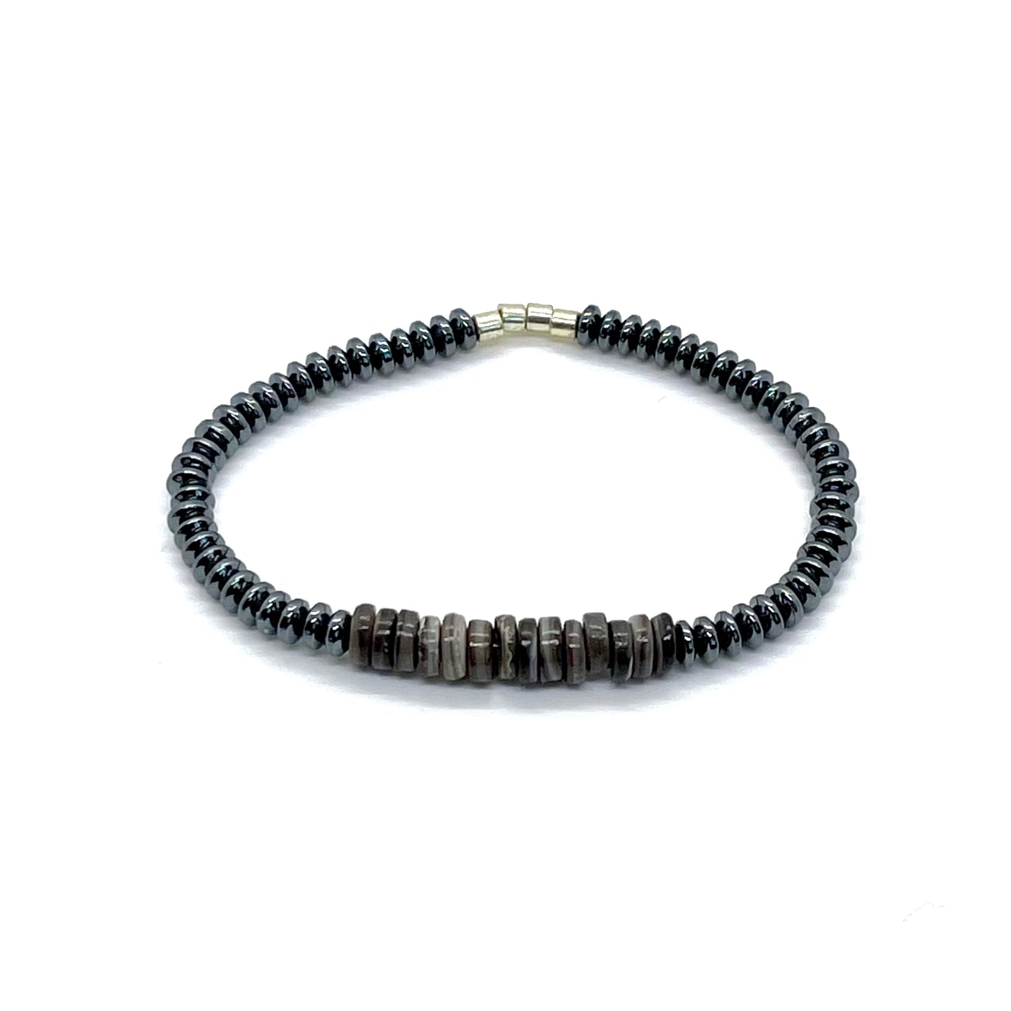 Men's hematite bracelet with gunmetal hematite disks and grey shell heshi disk beads on elastic stretch cord.