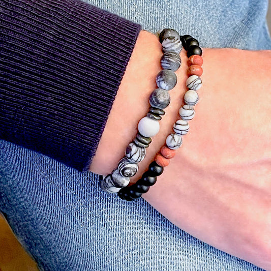 Men’s layered hand-beaded stretch bracelets with black onyx, white & black silk stone, red jasper rondelles, & pewter spacers