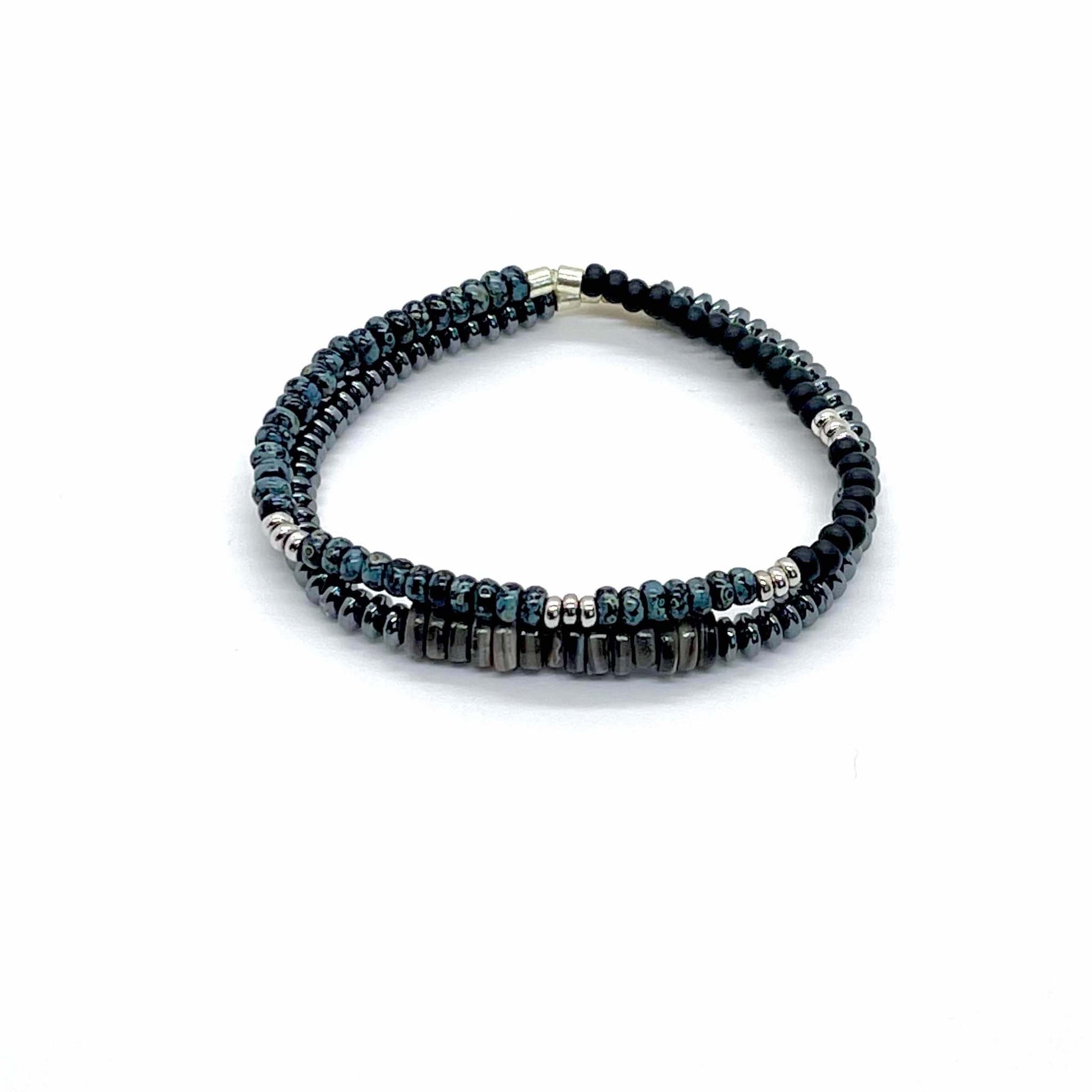 Men’s bracelet set with a hematite bracelet with shells, and a men's black beaded bracelet with silver and blue marble beads.