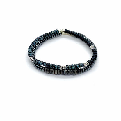 Men’s bracelet set with a hematite bracelet with shells, and a men's black beaded bracelet with silver and blue marble beads.
