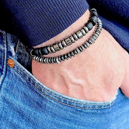 Men’s hand-beaded stackable stretch bracelets with black onyx & gray hematite beads, and gray shell & hemalyke heishi beads.