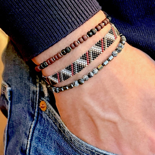 Men's beaded bracelet stack with red, brown, black, and gray thin wristband and 2 stretch seed bead and gemstone bracelets.
