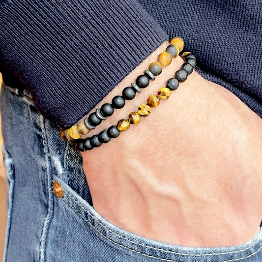 Men’s stackable smooth and faceted tiger’s eye and black onyx beaded stretch bracelets with pewter accent disk beads.