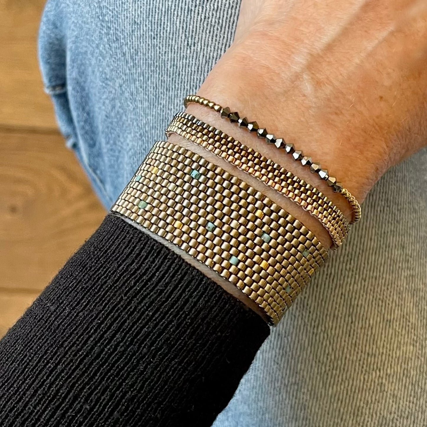 Metallic bracelet stack | Black hematite stretch gold ball bracelet | Pewter/bronze-tone seed bead woven bracelets.