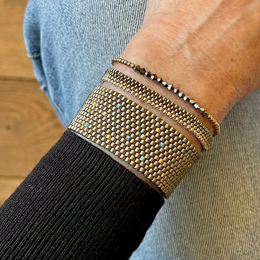 Metallic bracelet stack | Black hematite stretch gold ball bracelet | Pewter/bronze-tone seed bead woven bracelets.