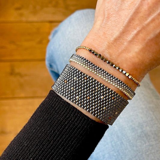 Metallilc bracelet stack with black gunmetal, bronze, and silver-tone seed beads | Gold-filled ball stretch bracelet with hematite crystal beads.