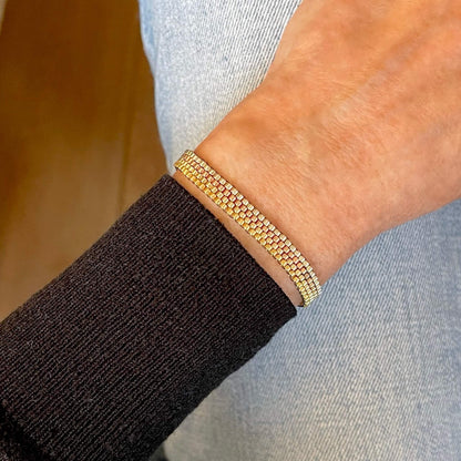Minimalist gold-tone metallic horizontal stripes seed bead bracelet.