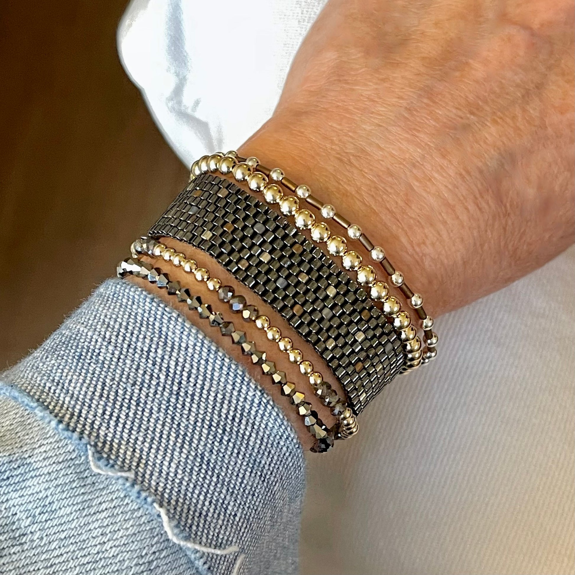 Mixed metal cuff and stretch bracelet stack with gunmetal, 14K gold fill, sterling silver, bronze and amber beads.