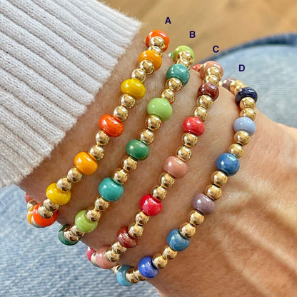 Beaded bracelets with monochromatic mixes of glass beads in reds, oranges, greens, and blues with 14k gold-filled beads.