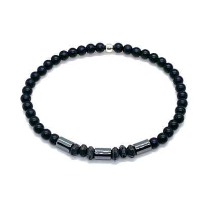 Onyx, hematite, and pewter thin mens bracelet with round, cylinder, and hexagon shaped beads.