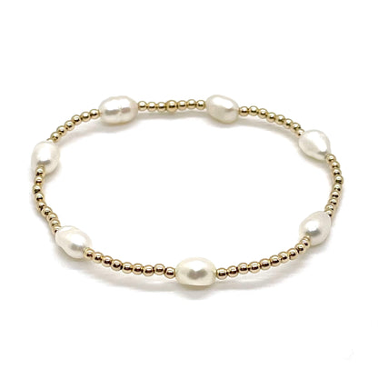 Pearl beaded bracelet with freshwater rice pearls and 2mm 14K gold fill ball beads on elastic stretch cord.