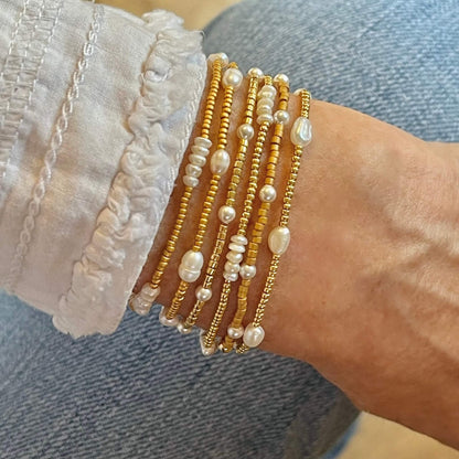 Pearl beaded stretch bracelets with tiny gold seed beads.