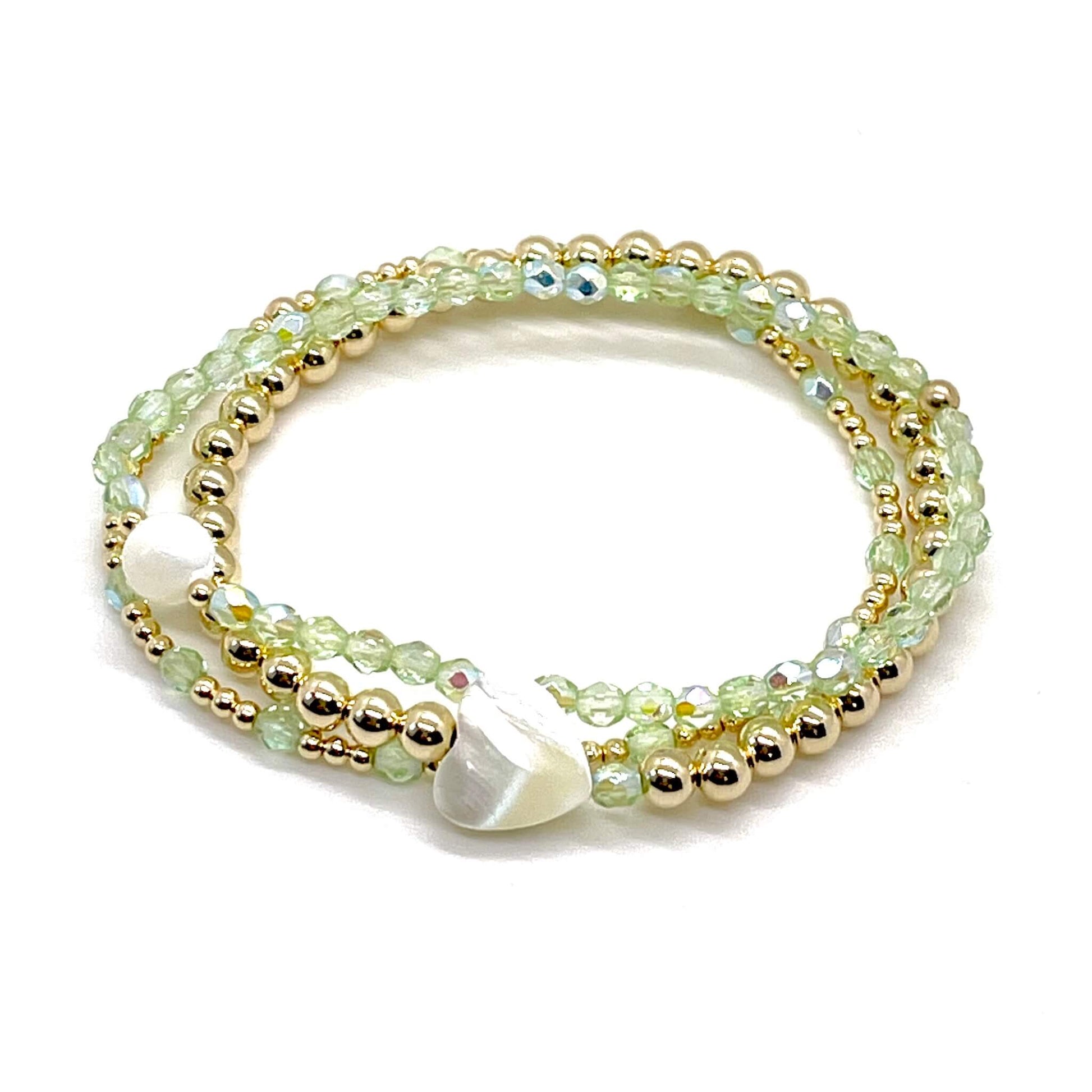 Peridot crystal and gold bracelet stack of 3. Womens handmade stretch bracelets wtih round and heart shaped mother-of-pearl accent beads.