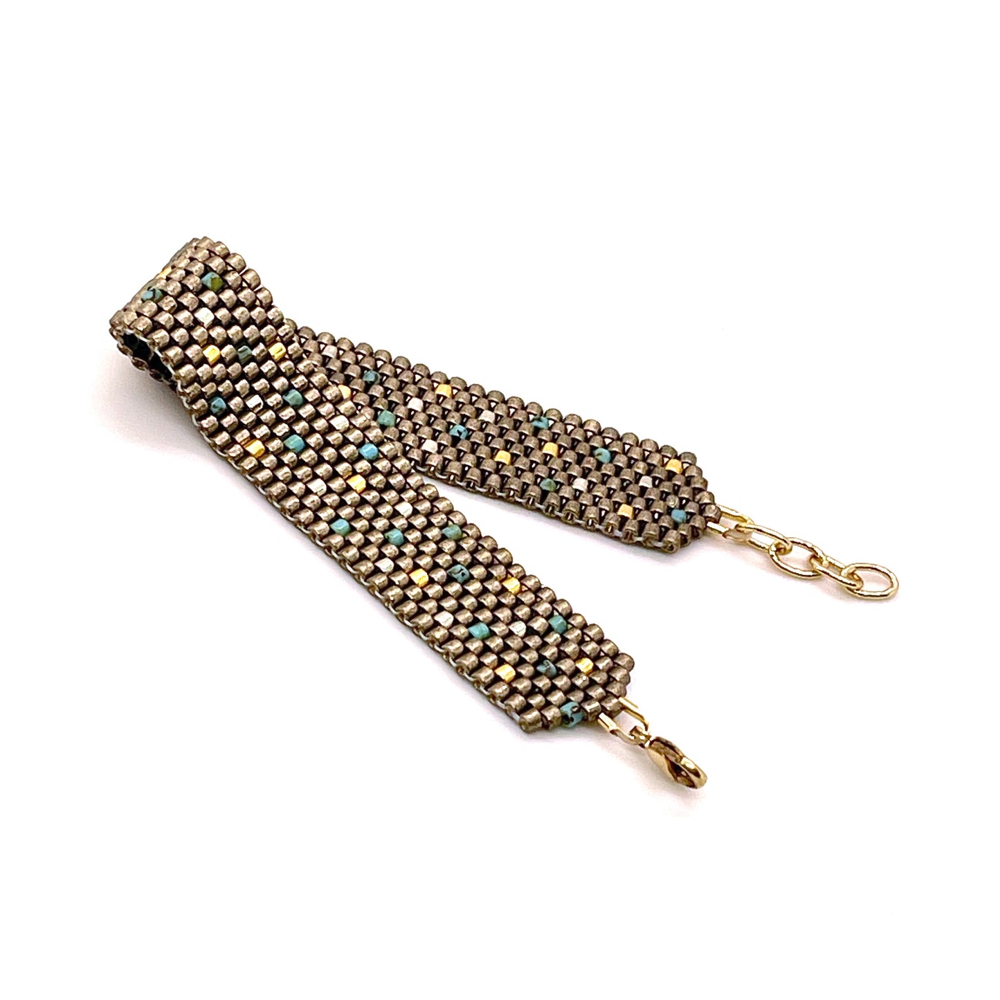 Bronze pewter handwoven seed bead bracelet with turquoise and gold beads sprinkled throughout.