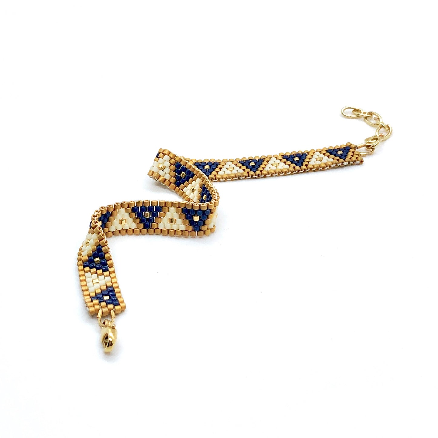 Peyote stitch woven triangle bracelet with blue, white, and gold beads.
