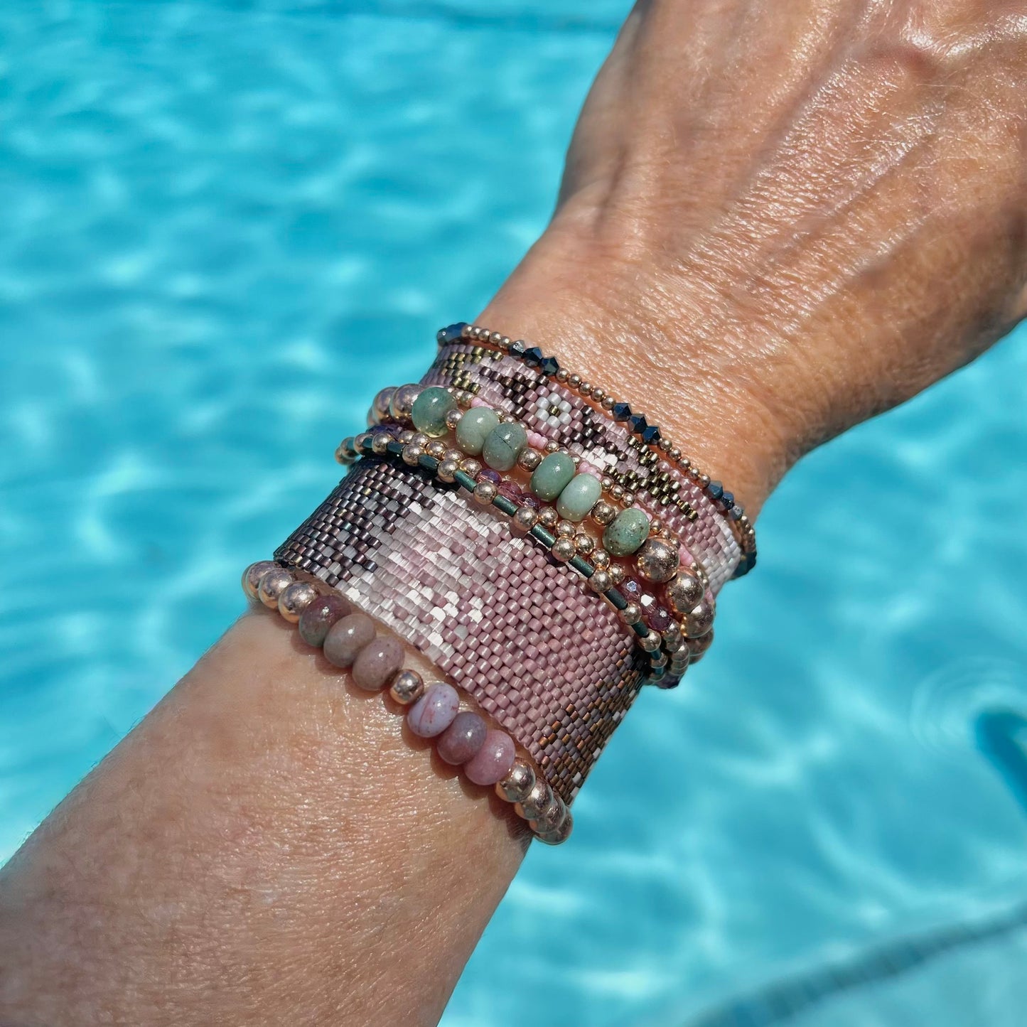 Pink bracelets with seed beads and 14K rose gold filled beads. Beautiful hand beaded bracelets that reflect the light and glisten on your wrist.