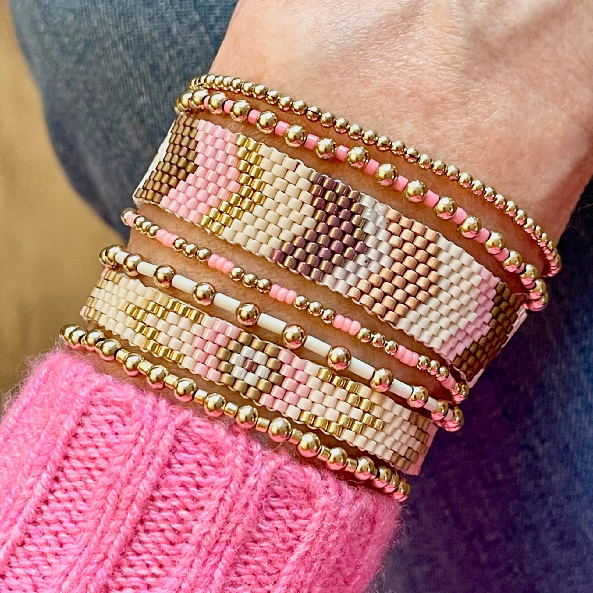 Gold bead bracelets and flat beaded bracelets. Trendy as stackable bracelets or individually. With pink beads.