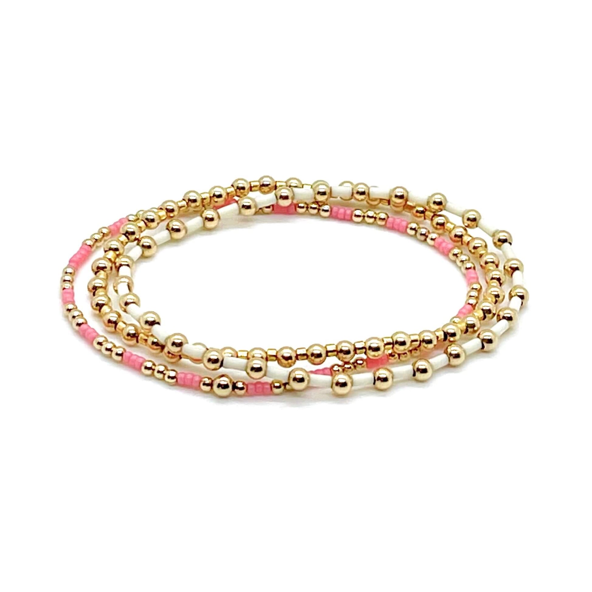 Pink and gold bracelet set with three 14k gold filled bead bracelets with alternating seed beads.