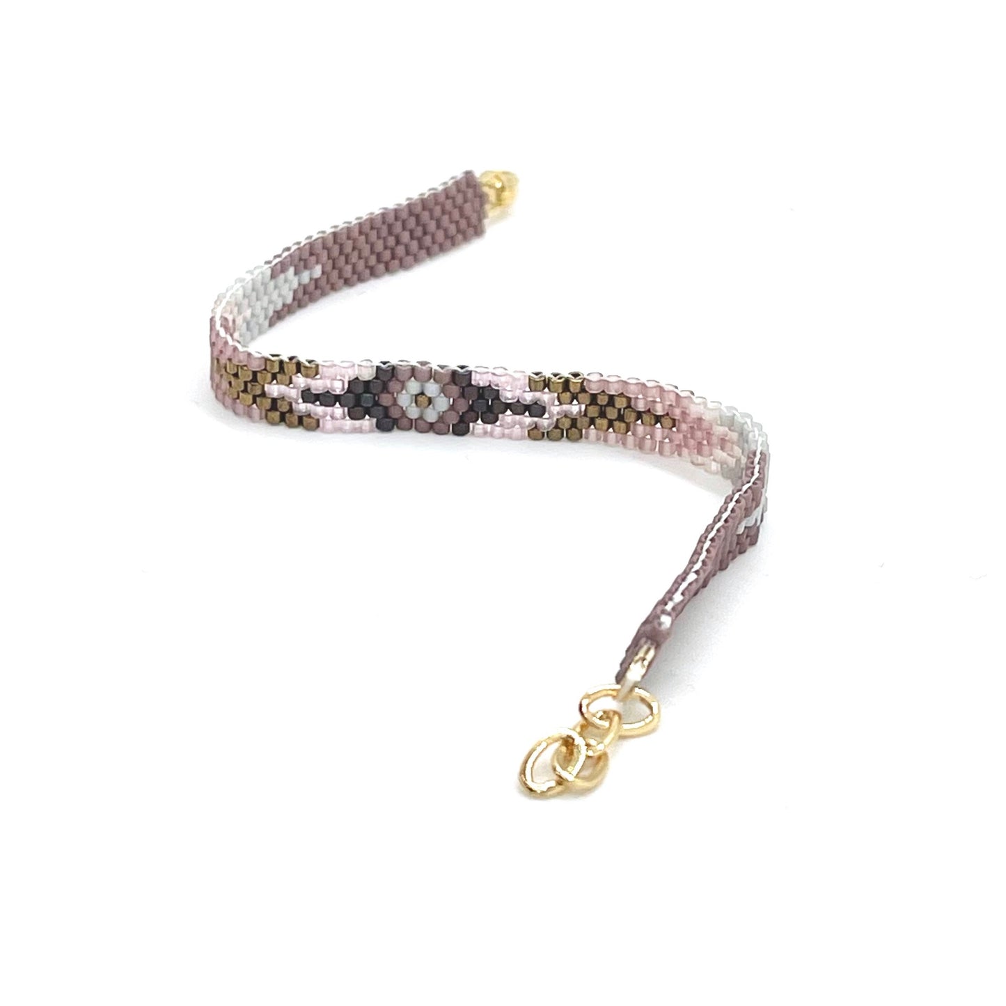 Purple beaded peyote stitch bracelet with seed beads in mauve, plum, rose, and bronze. Hand stitched in an arrow pattern with a flower center.
