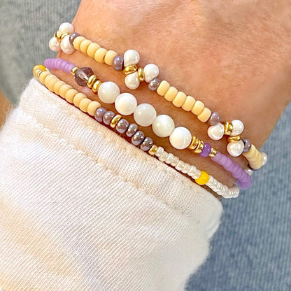 Purple seed bead and pearl drop beaded bracelet stack of 3. Skinny stretch bracelets for women.