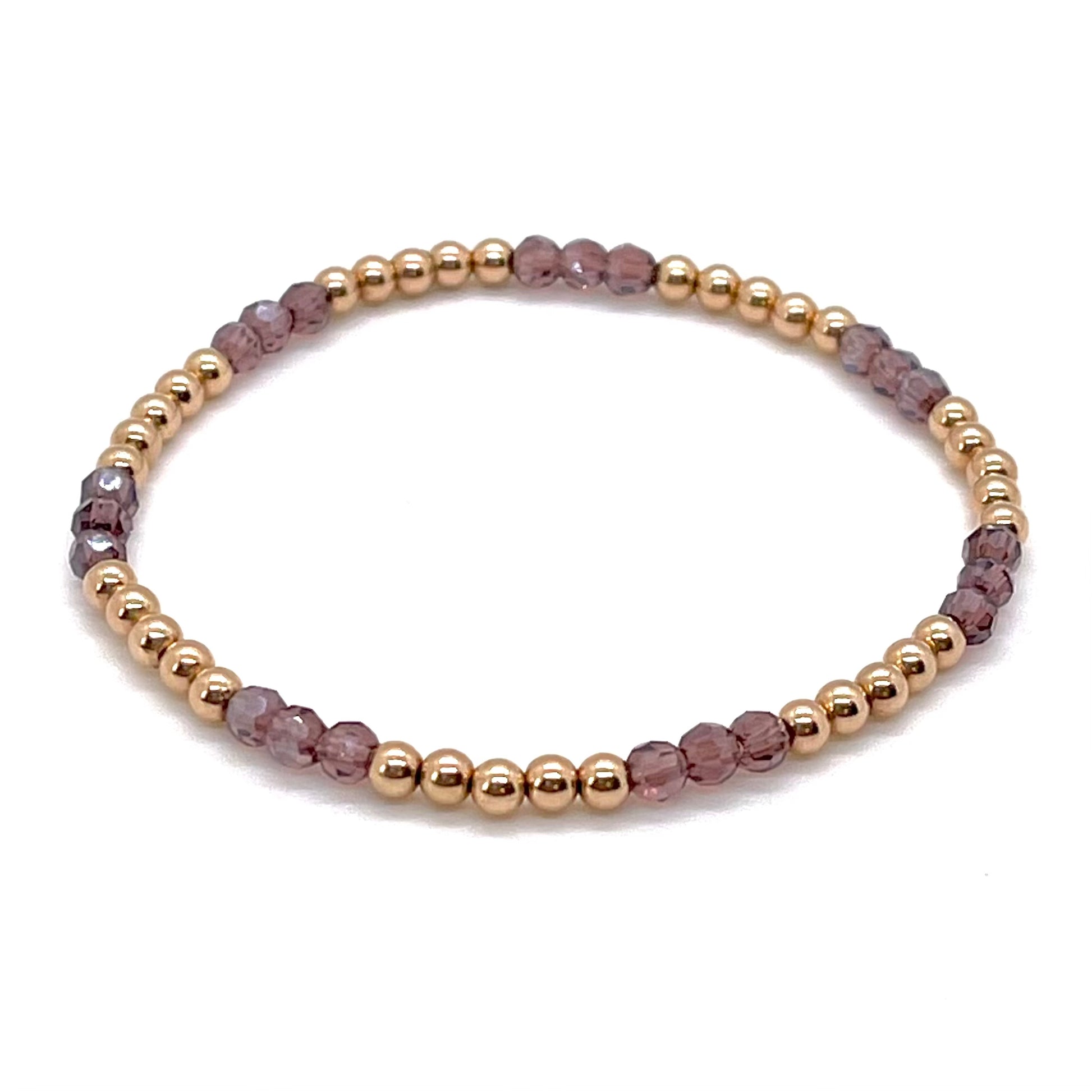 Rose gold bracelet for women with amethyst faceted glass beads and 14K rose gold filled 3mm balls on elastic stretch.