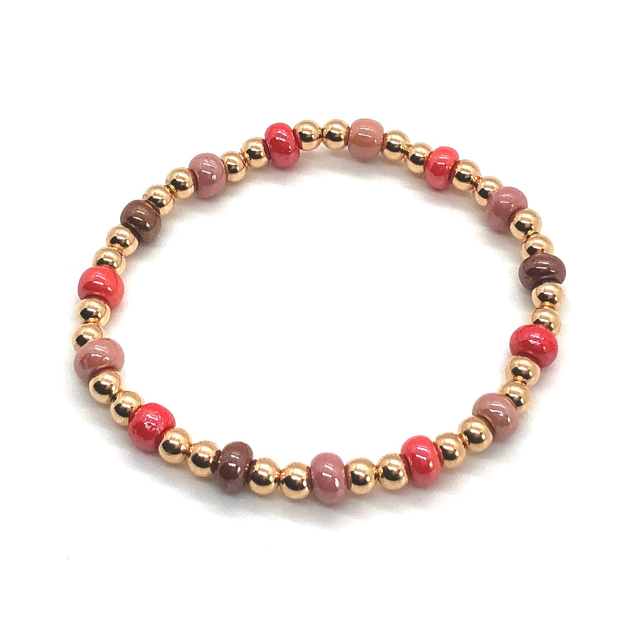 Rose gold bracelet with 4mm balls and red and pink beads on stretch cord.