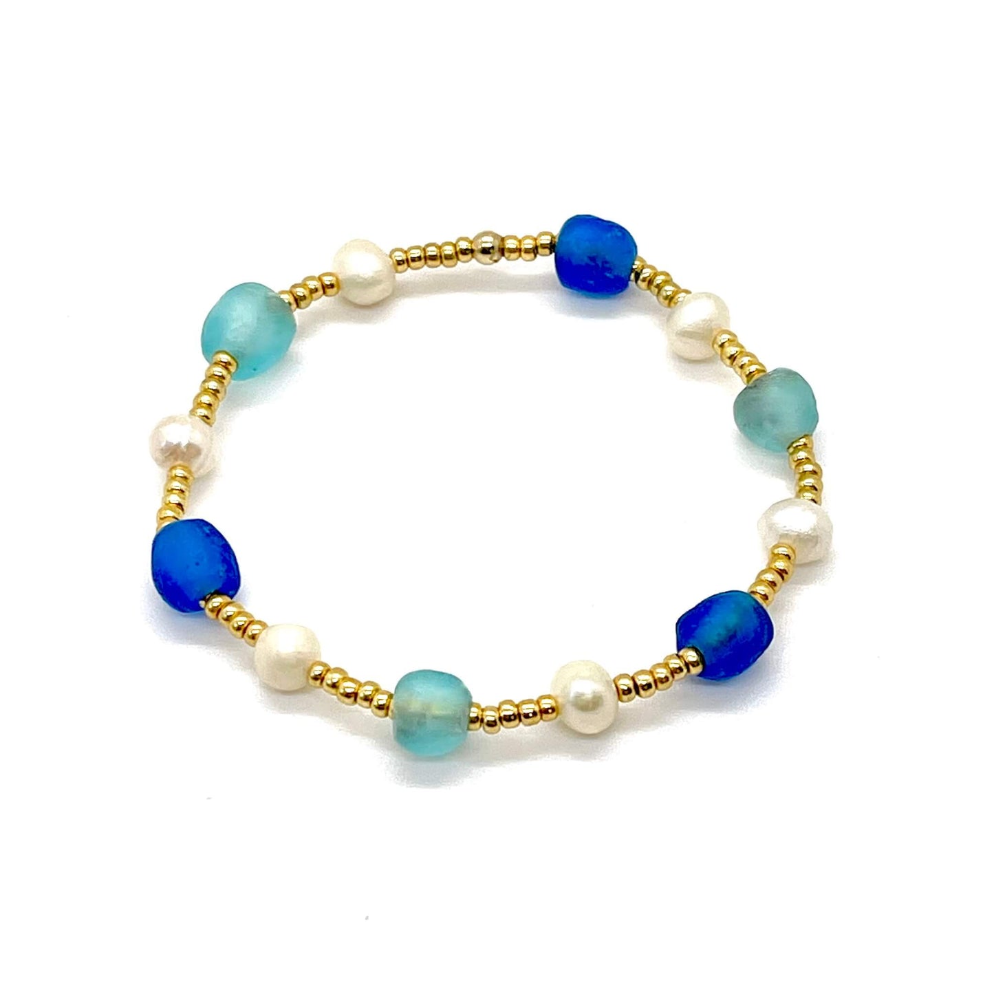 Sea glass bracelet with blue and aqua beach glass, freshwater pearls, and gold tone seed beads.
