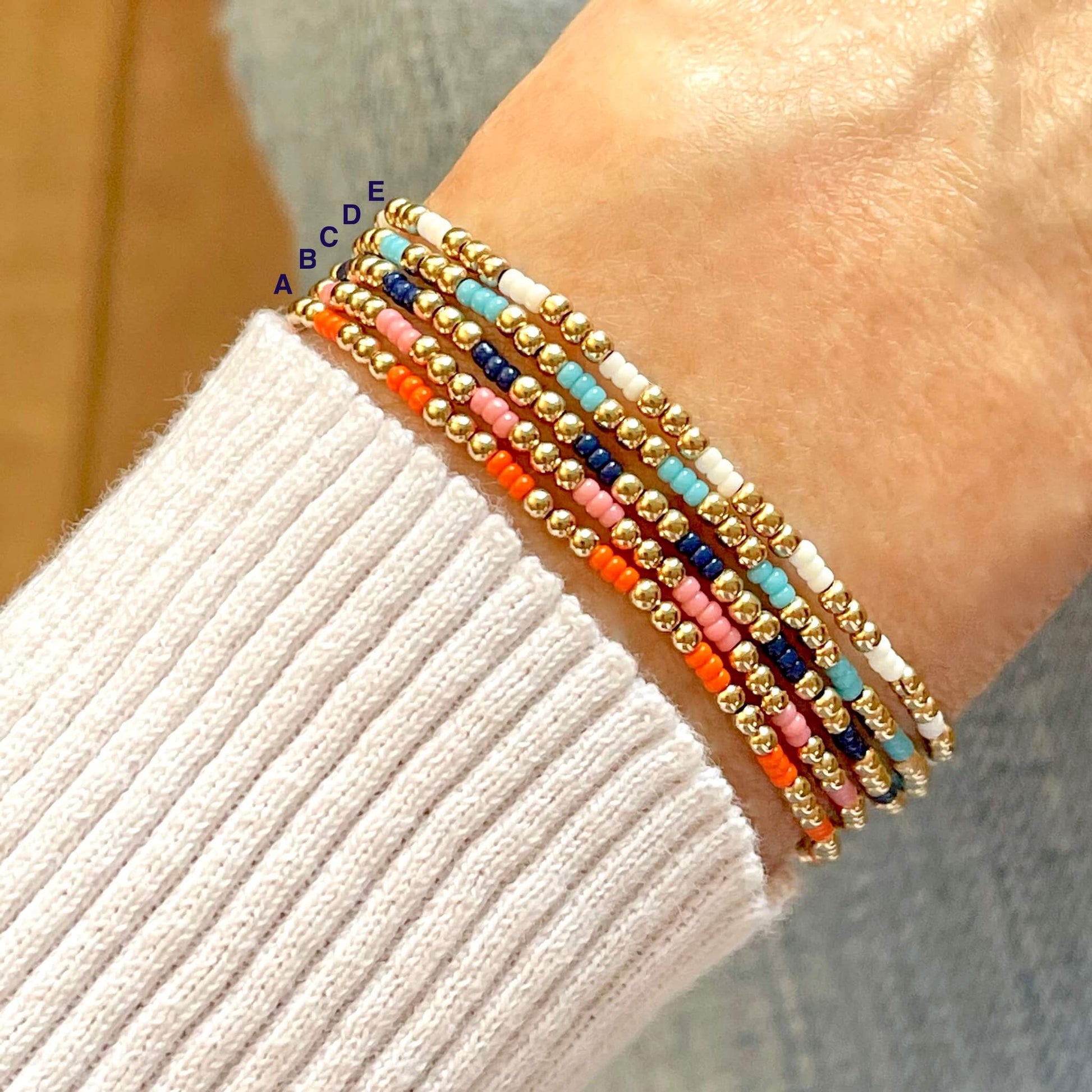 Seed bead bracelets with small colorful seed beads and 2mm 14K gold filled beads on elastic stretch cord.