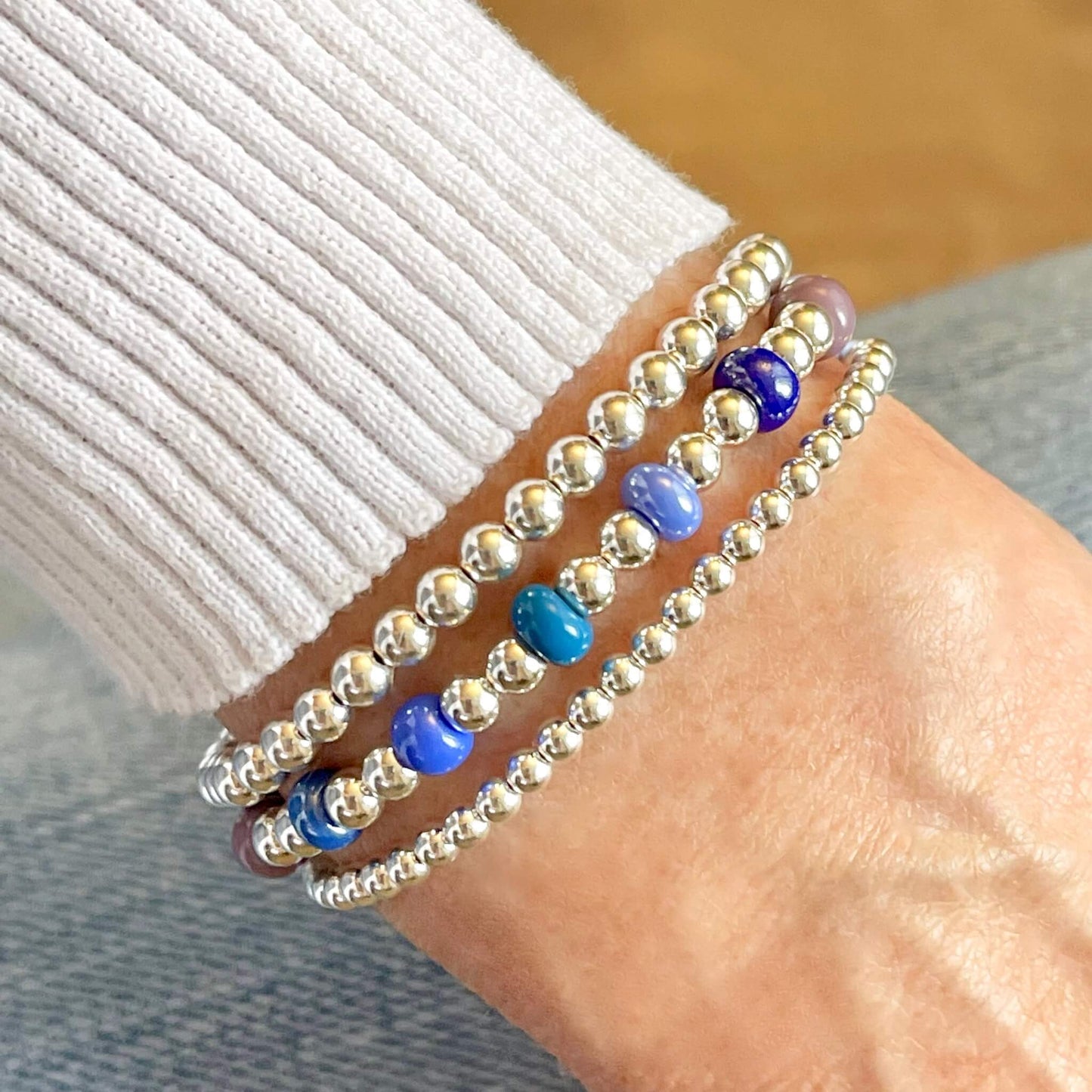 Set of 3 Monochromatic Beaded Stretch Bracelets in Silver and Shades of Blue & Plum.