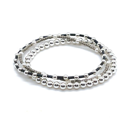 Silver stretch bracelets wtih grey and slate seed beads and cyrstal pearls.
