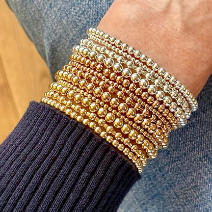 Stacking bracelets with 14K gold filled and sterling silver balls. Waterproof and tarnish resistant stretch bracelets.