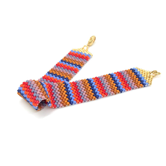 Birght and warm colorful striped seed bead wide woven bracelet band with lobster clasp. Modern, southwestern style for everyday wear.
