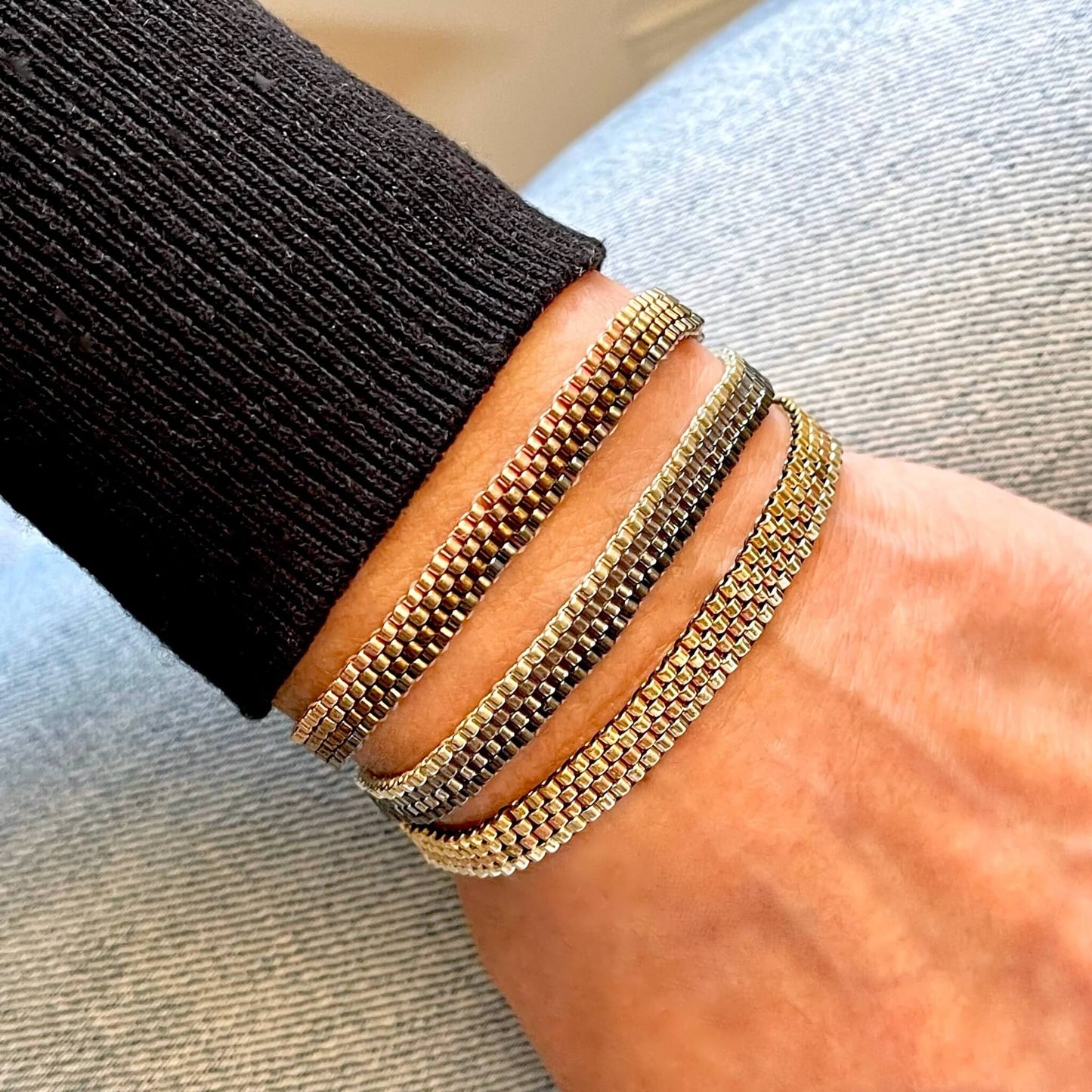 Trending beaded bracelets with metallic seed beads. Horizontal striped ombre pattern.
